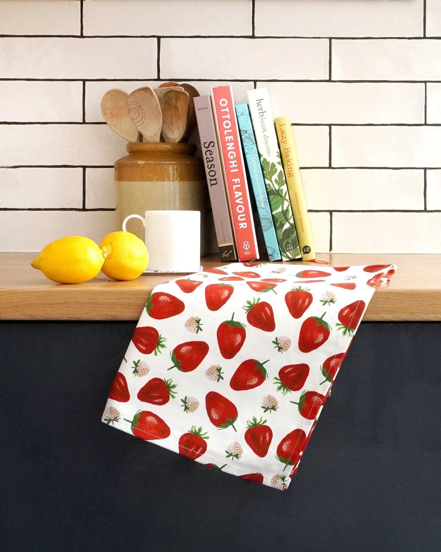 Cotton kitchen linen featuring red strawberries